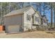 Exterior view with attached garage and partial stone facade at 13 Cliff Ct, Villa Rica, GA 30180