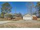 View of the garage and covered parking area, showcasing a driveway and fenced area at 13 Cliff Ct, Villa Rica, GA 30180