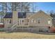 Charming home exterior with a spacious yard, wooden fence, and deck for outdoor enjoyment at 13 Cliff Ct, Villa Rica, GA 30180