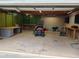 Spacious garage featuring work benches, large desk and riding lawn mower at 13 Cliff Ct, Villa Rica, GA 30180