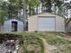 Exterior view of a metal shed, showing a large garage door and smaller storage shed at 13 Cliff Ct, Villa Rica, GA 30180