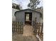 Outdoor storage shed featuring metal siding, a green roof, and a gravel floor at 13 Cliff Ct, Villa Rica, GA 30180