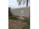 View of a metal storage shed with a door and small pet door in a residential setting at 13 Cliff Ct, Villa Rica, GA 30180