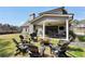 Beautiful backyard with a fire pit, outdoor seating, and a covered patio for entertaining at 220 Alcovy Reserve Way, Covington, GA 30014