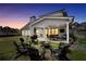 Outdoor area featuring a fire pit, seating, and covered patio, perfect for evening gatherings at 220 Alcovy Reserve Way, Covington, GA 30014