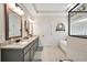Bright bathroom featuring a glass enclosed shower, soaking tub, patterned tile floor, and granite countertops at 220 Alcovy Reserve Way, Covington, GA 30014