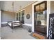 Inviting front porch featuring a hanging swing, wood accents, and a charming welcome sign near the front door at 220 Alcovy Reserve Way, Covington, GA 30014