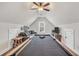 Game room features vaulted ceilings, pool table, comfortable seating, and built-in storage at 220 Alcovy Reserve Way, Covington, GA 30014