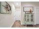 Inviting hallway featuring neutral walls and a decorative cabinet at 220 Alcovy Reserve Way, Covington, GA 30014