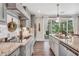 Kitchen featuring gray cabinets, stainless steel appliances, granite countertops, and access to backyard at 220 Alcovy Reserve Way, Covington, GA 30014