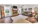 Cozy living room with stone fireplace, plush seating, and natural light at 220 Alcovy Reserve Way, Covington, GA 30014