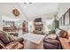 Spacious living room featuring a stone fireplace, large windows, and modern decor at 220 Alcovy Reserve Way, Covington, GA 30014