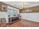 Living room featuring hardwood floors, wainscoting, a large window, and tasteful decorations at 220 Alcovy Reserve Way, Covington, GA 30014