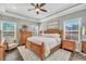 Spacious main bedroom with tray ceilings, ceiling fan, and lots of natural light at 220 Alcovy Reserve Way, Covington, GA 30014