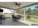 Enjoy outdoor dining on this covered patio with ceiling fan and lovely backyard views at 220 Alcovy Reserve Way, Covington, GA 30014