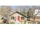Charming single-Gathering home featuring a red front door, well-maintained lawn, and classic architectural details at 2363 Paul Nw Ave, Atlanta, GA 30318