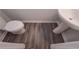 A half-bath includes luxury vinyl plank flooring, a toilet and white pedestal sink at 492 Charleston Pl, Villa Rica, GA 30180
