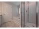 Bathroom view showcasing a soaking tub, glass-enclosed shower, and door at 492 Charleston Pl, Villa Rica, GA 30180