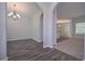 Dining room featuring hardwood floors, neutral walls, an ornate chandelier, and an arched doorway at 492 Charleston Pl, Villa Rica, GA 30180