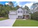 Two-story home showcasing stone accents, neutral siding, a well-manicured lawn, and a two-car garage at 492 Charleston Pl, Villa Rica, GA 30180