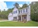 Two-story home showcasing stone accents, neutral siding, a well-manicured lawn, and a two-car garage at 492 Charleston Pl, Villa Rica, GA 30180