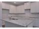 Spacious kitchen with white cabinets, granite counters, and modern appliances at 492 Charleston Pl, Villa Rica, GA 30180