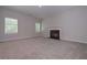 Cozy living room with plush carpet, fireplace, and ample natural light at 492 Charleston Pl, Villa Rica, GA 30180