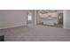 Open-concept living space with plush carpet, wood floors, and a modern kitchen at 492 Charleston Pl, Villa Rica, GA 30180