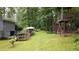Expansive backyard featuring a garden, patio, and a whimsical playhouse with a swing set at 1880 Doefield St, Canton, GA 30115