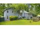 Backyard view of a blue house with a large, green lawn and garden area at 1880 Doefield St, Canton, GA 30115
