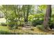 The backyard has a garden bench and lush foliage, creating a peaceful retreat at 1880 Doefield St, Canton, GA 30115