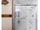 Close up on renovated bathroom featuring a large glass enclosed shower with new tile at 1880 Doefield St, Canton, GA 30115