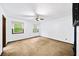 Large bedroom with neutral carpet, ceiling fan and natural light from windows at 1880 Doefield St, Canton, GA 30115