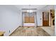 Bright dining area with wood-look floors, a large window, and modern lighting fixture at 1880 Doefield St, Canton, GA 30115