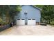 A two-car garage is featured on this blue home with an adjacent stairway leading to the upper level at 1880 Doefield St, Canton, GA 30115