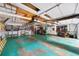Spacious garage with teal painted floor and shelving; perfect for workshop or storage at 1880 Doefield St, Canton, GA 30115