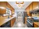 Spacious kitchen with wood cabinets, stainless steel appliances, updated floor, and adjacent eating area at 1880 Doefield St, Canton, GA 30115