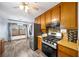 Traditional eat-in kitchen featuring stainless steel appliances, wood cabinets, and updated flooring at 1880 Doefield St, Canton, GA 30115