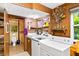 Efficient laundry room with washer, dryer, sink, storage, and natural light at 1880 Doefield St, Canton, GA 30115