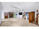 Large open living room with a stone fireplace, neutral carpeting, and multiple access points at 1880 Doefield St, Canton, GA 30115