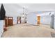 Open living area with a stone fireplace, carpeted floor, and access to the kitchen and dining spaces at 1880 Doefield St, Canton, GA 30115