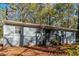 Charming one-story home featuring a gray brick foundation and siding surrounded by mature trees at 2500 Swallow Circle Southeast Se Cir, Atlanta, GA 30315