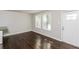 Inviting living room with gleaming hardwood floors, a bright front door and large windows at 2500 Swallow Circle Southeast Se Cir, Atlanta, GA 30315