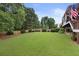 Expansive backyard features mature trees, lush lawn, well-manicured landscaping, and a privacy fence at 2738 Riderwood Ne Ln, Marietta, GA 30062