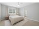 Bright bedroom featuring neutral carpet, fan, and natural light from the large window at 2738 Riderwood Ne Ln, Marietta, GA 30062