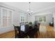 Bright dining room features hardwood floors, a dark wood table, and large windows with plantation shutters at 2738 Riderwood Ne Ln, Marietta, GA 30062
