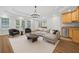 Living room with seating area, bar, and windows providing view to back yard at 2738 Riderwood Ne Ln, Marietta, GA 30062