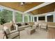 Screened-in sunroom with ceiling fans, neutral color scheme, and comfortable seating arrangement at 2738 Riderwood Ne Ln, Marietta, GA 30062