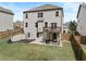 Fenced backyard boasts a patio, swing set, deck, and expansive green space for recreational activities at 4568 Mantova Dr, Buford, GA 30519