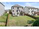 Large, fenced backyard featuring a patio, swing set, and deck, offering great outdoor living at 4568 Mantova Dr, Buford, GA 30519